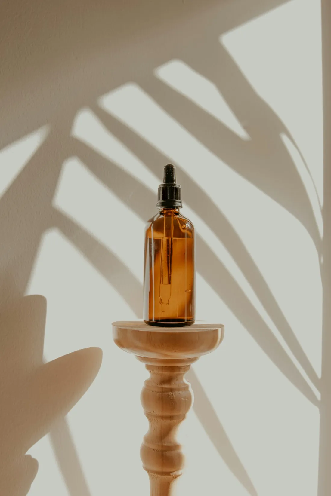 Amber bottle of aroma oil in warm light